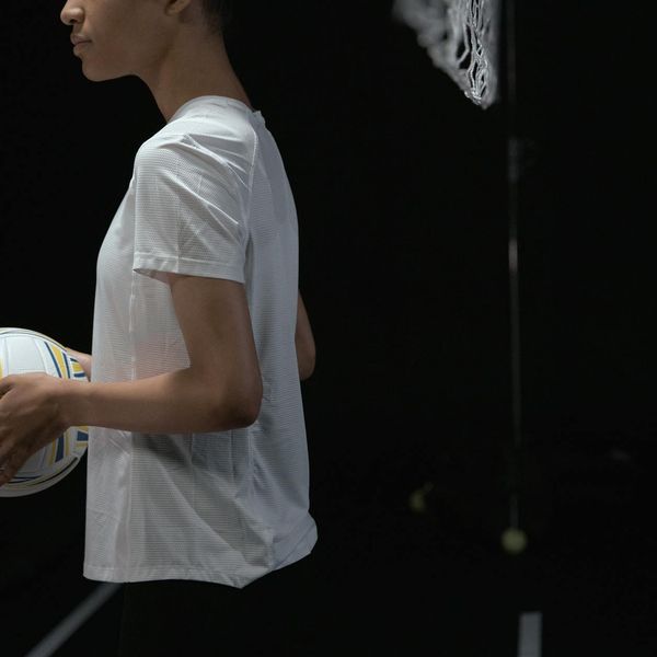 Athlete holding a kettlebell, showing focus and balance in a studio.